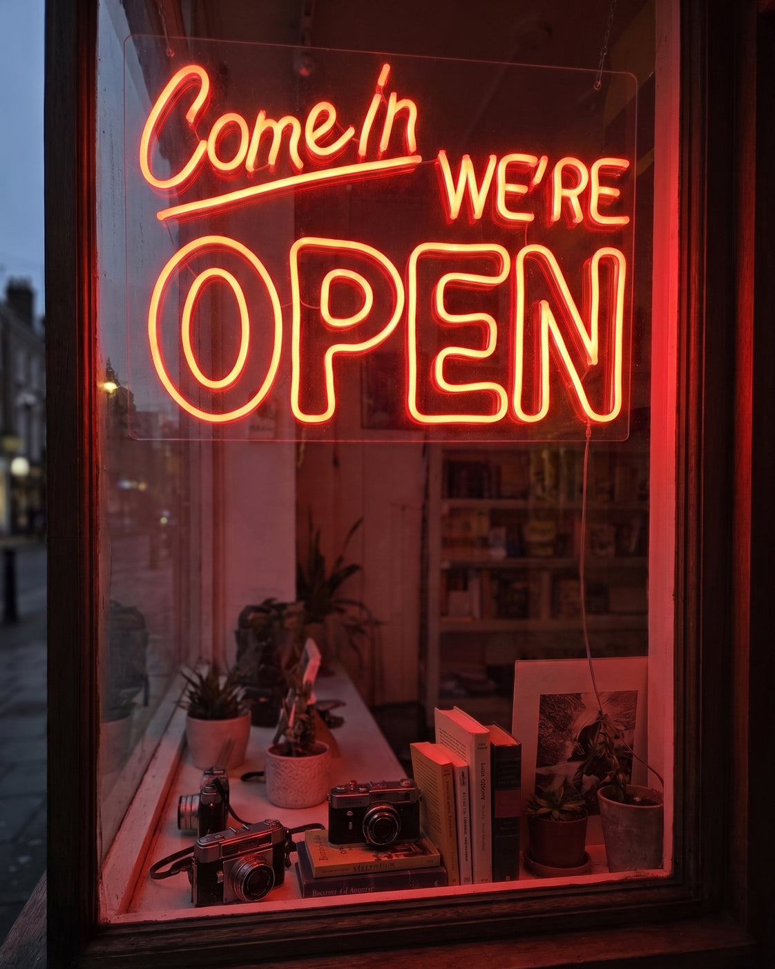 A boutique café using a custom coffee and leaf neon icon to attract customers